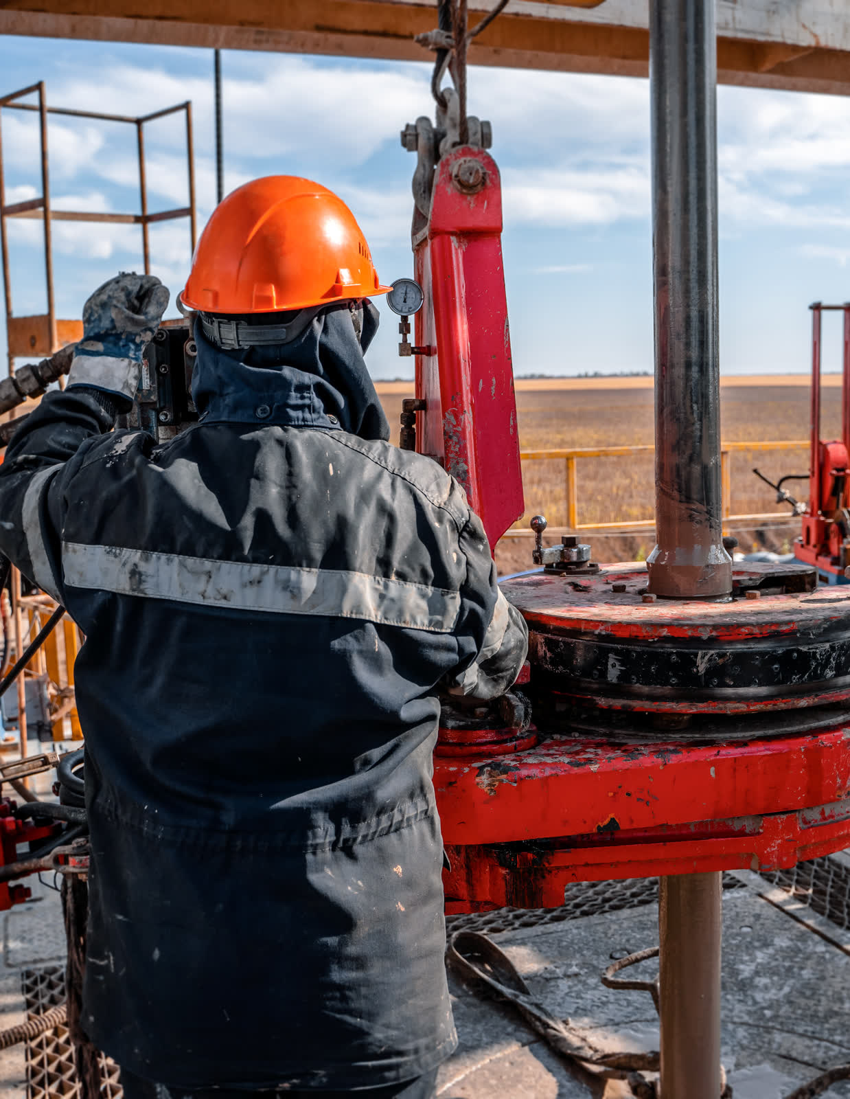 Rig crew working on well equipment at the rig floor